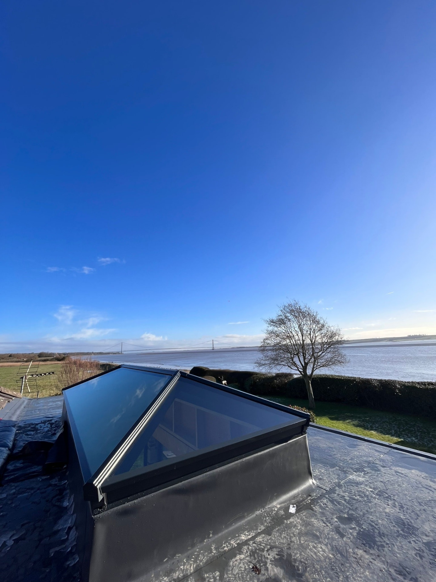 Wide view across the Humber estuary from a roof with a new Korniche roof lantern