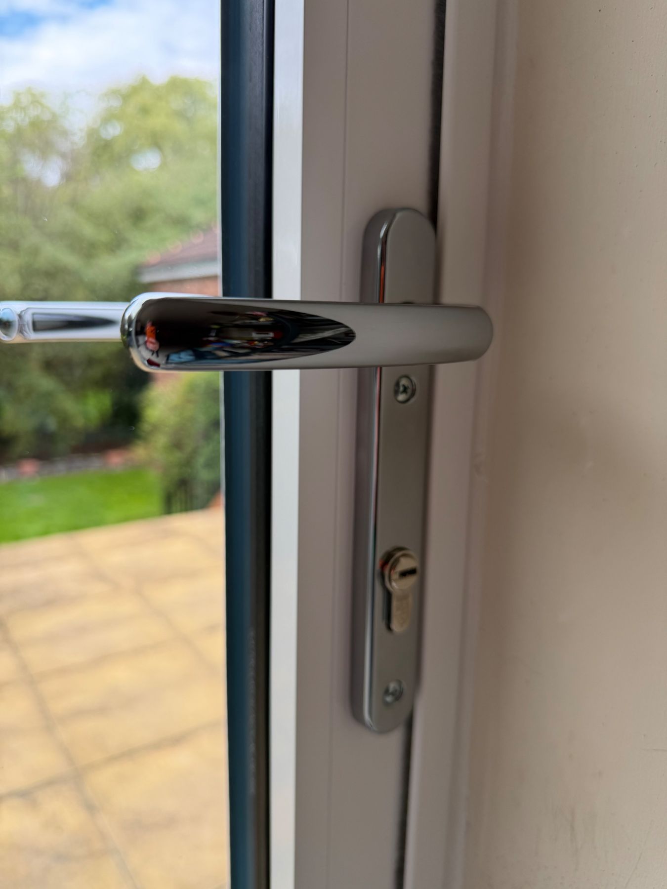 Chrome handle detail on white aluminium bifold doors