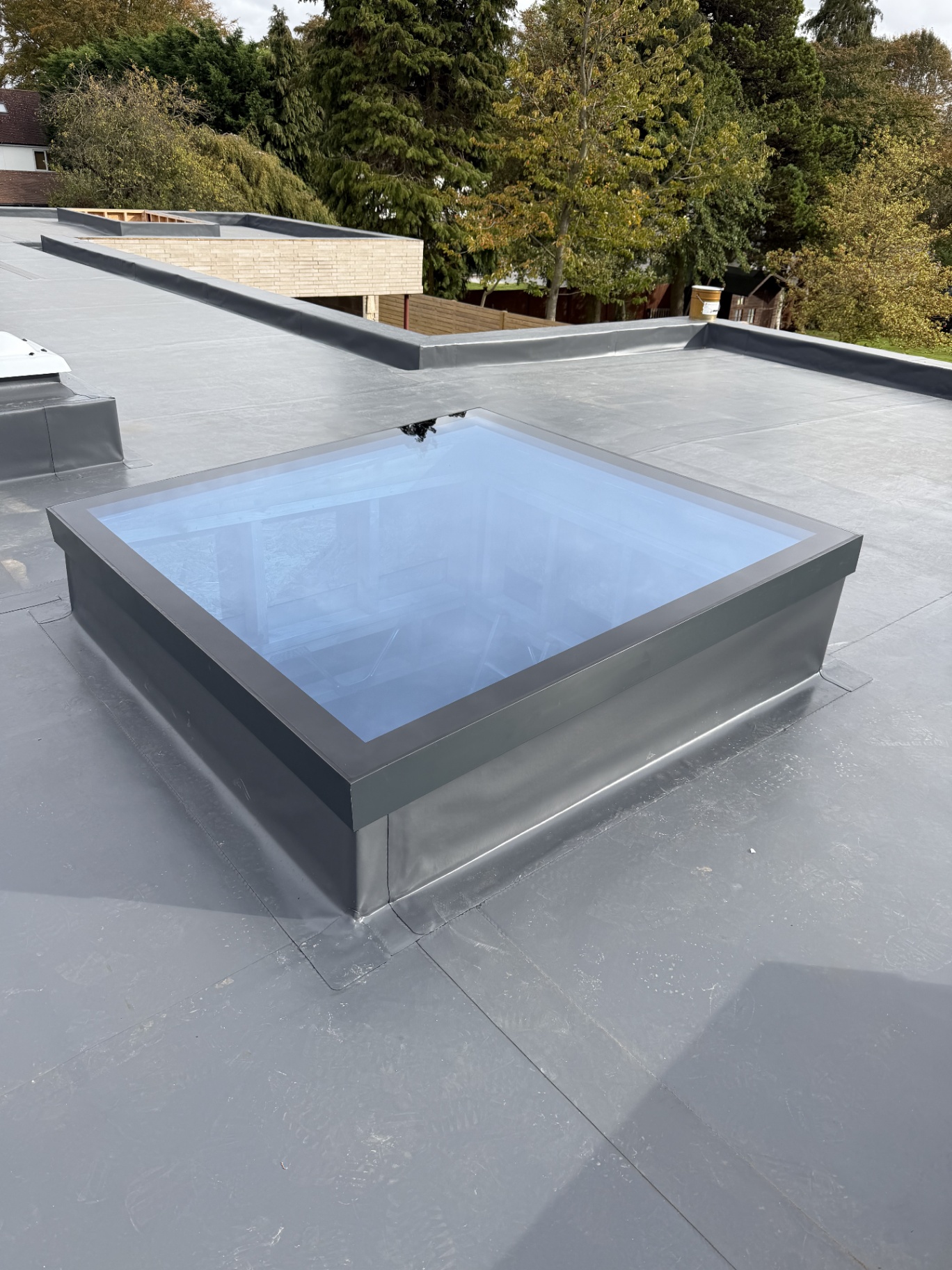 Infinity framed flat rooflight installed on a grey flat roof