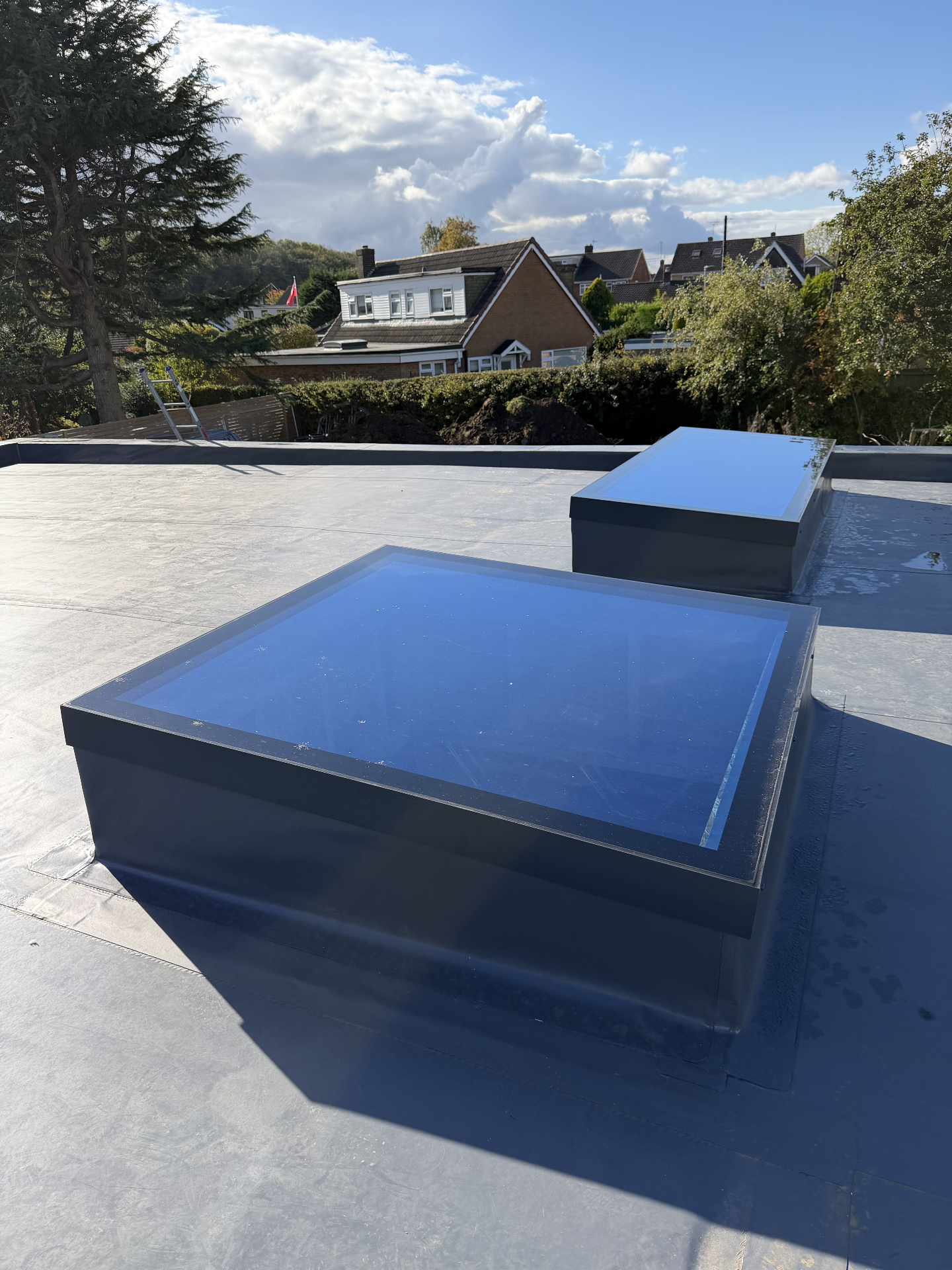 Anthracite Infinity framed flat rooflight with rooftops beyond