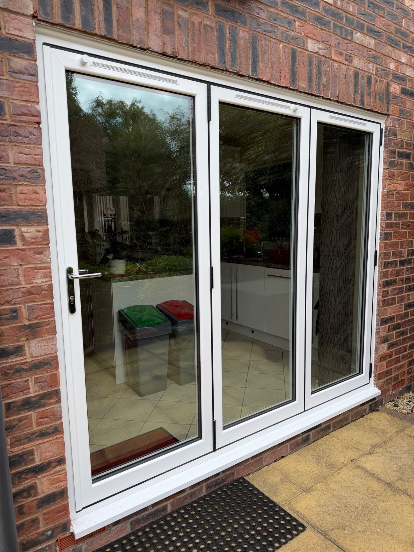 Closed white aluminium bifold doors at a WGS installation in Hull