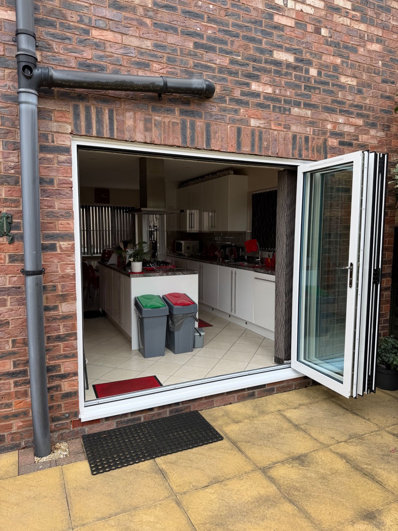 White aluminium bifold doors fully open onto a patio in Hull HU5