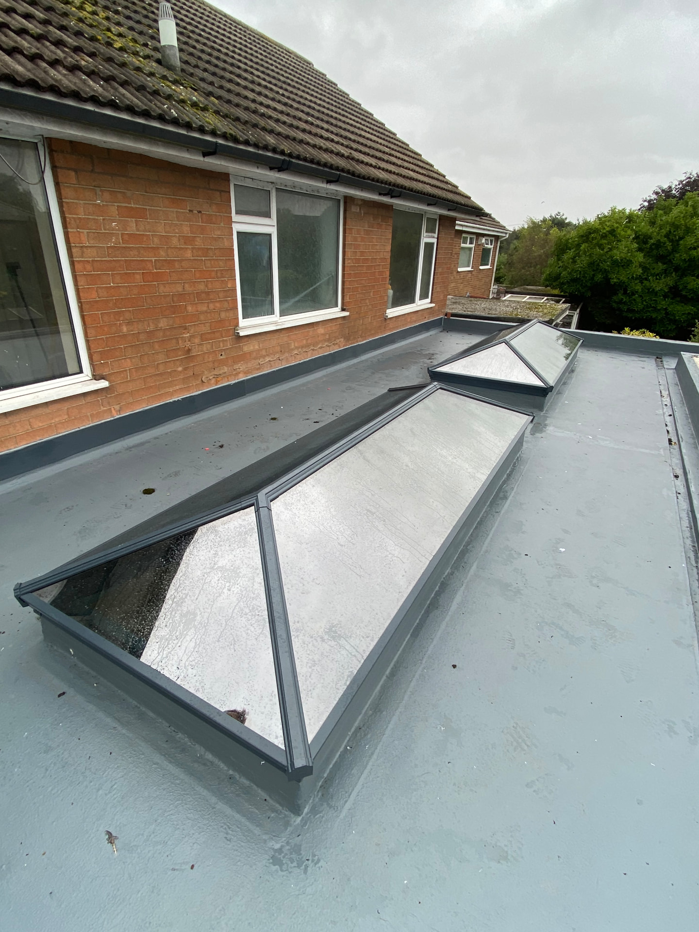 Grey Korniche roof lanterns along a long residential extension