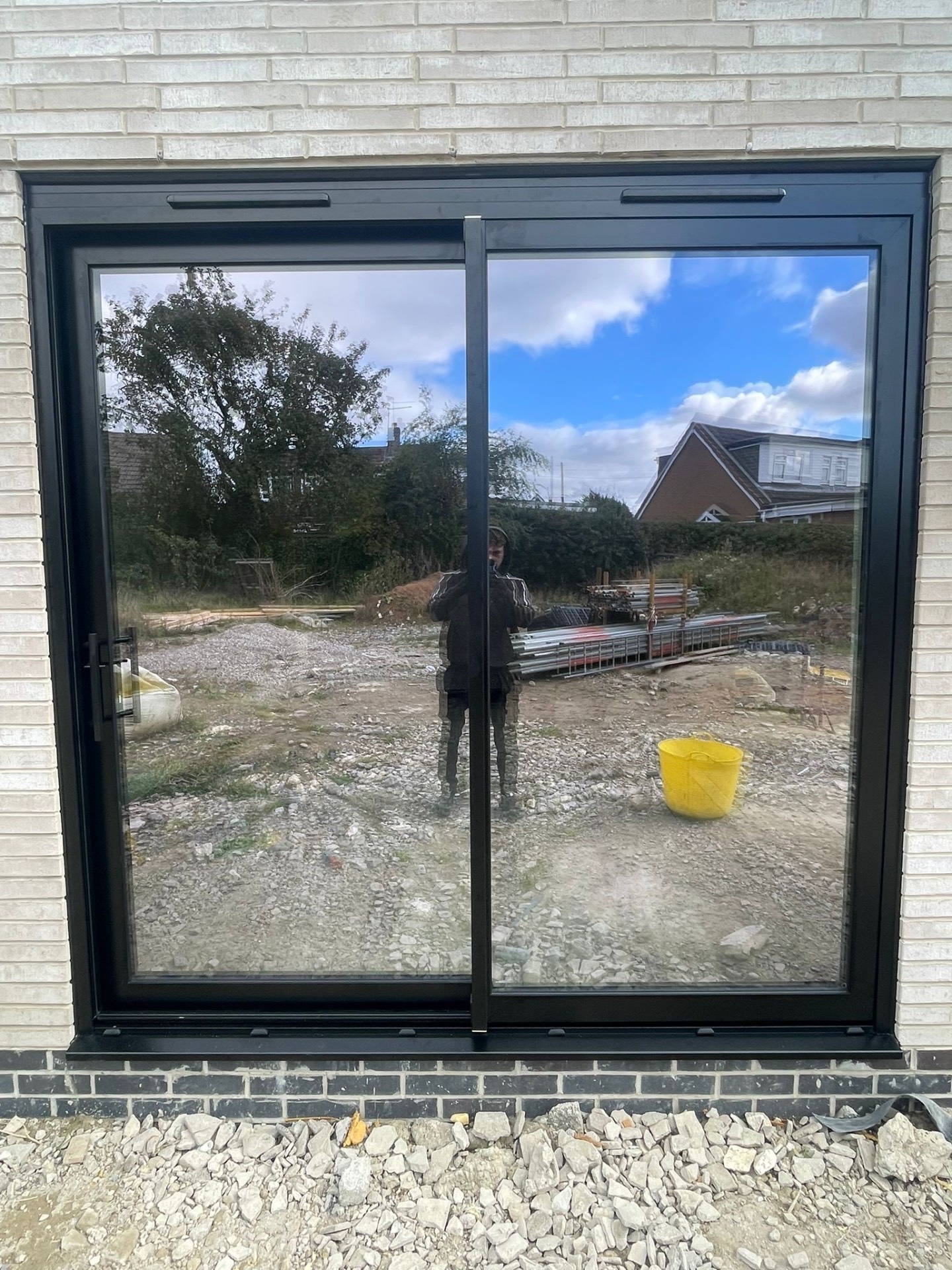 Two-panel ALUNA aluminium sliding patio door during installation in a new extension