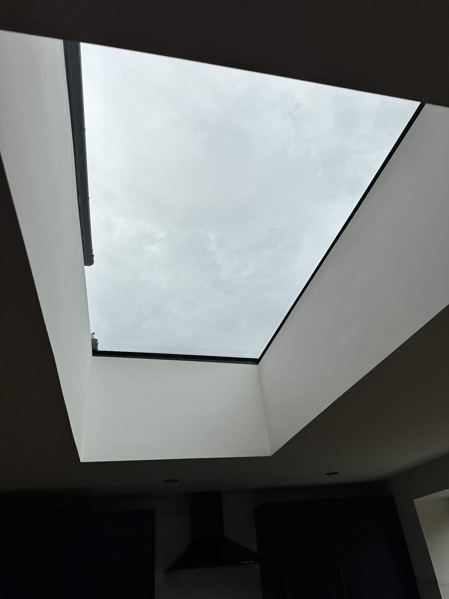 Interior kitchen view looking up through a large Infinity framed flat rooflight
