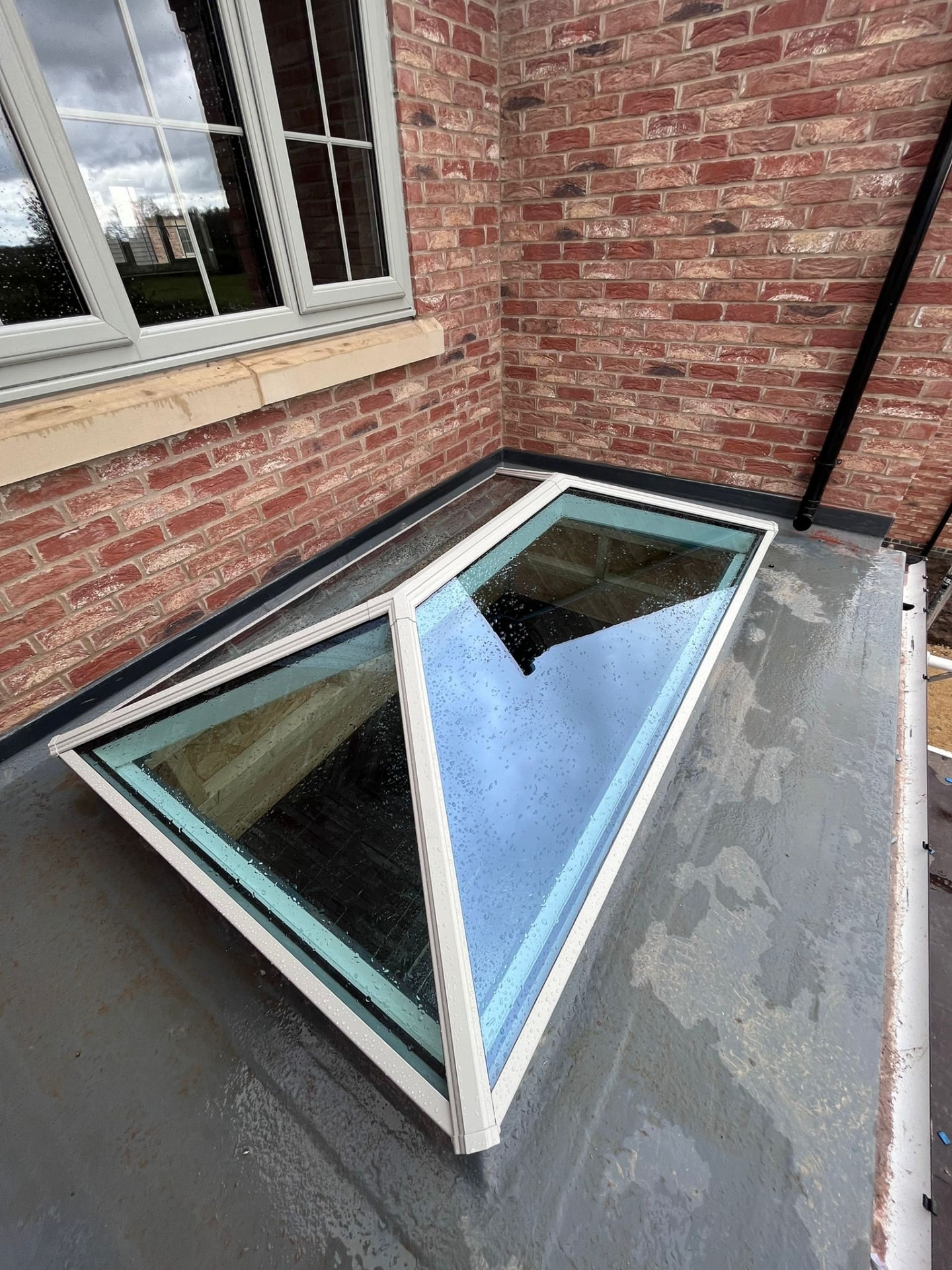 Agate grey Korniche roof lantern against red brickwork